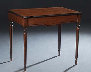 French Louis XVI Style Carved Pitchpine Writing Table, late 19th c., the rounded edge top over a long frieze drawer, on turned tapered reeded legs, wi