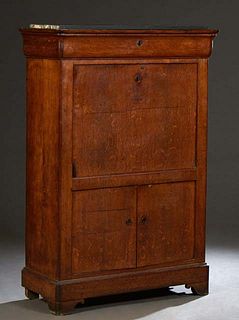 French Carved Oak Secretary Abattant, 19th c., with a cavetto frieze drawer over a fall front desk with an inset leather writing surface in front of o