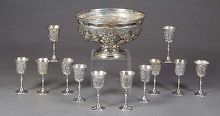 Contemporary Indian Silverplated Punch Set, 20th c., consisting of a large bowl with repousse grape and leaf decoration, together with 12 footed goble