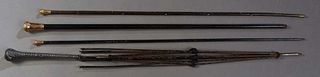Group of Three Canes, late 19th c., and an umbrella frame, the three ebonized canes with gold filled ball handles; the umbrella with a weighted silver