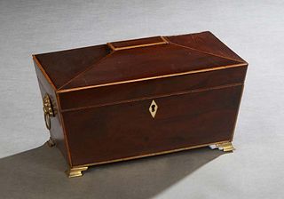 English Line Inlaid Mahogany Sarcophagus Form Tea Caddy, 19th c., with ringed lions' head handles and an ivory escutcheon, the interior with two foil 
