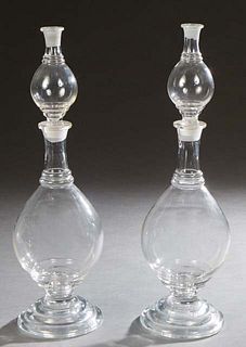 Unusual Pair of Apothecary Mold Blown Glass Show Globes, 20th c., in four parts, the teardrop stopper fitted in a hollow glass top over a baluster cen