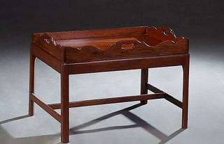 English Carved Mahogany Butler's Tray on Stand, 20th c., the serpentine sides with hand holes, on a base with square legs joined by rectangular stretc