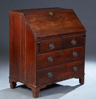 English Carved Mahogany Slant Front Desk, 19th c., the slanted leather inset lid opening to an interior fitted with fifteen drawers and a central cupb