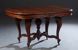 French Louis XV Style Carved Walnut Dining Table, early 20th c., the stepped oval top opening to accept leaves, on a central twist carved urn support 