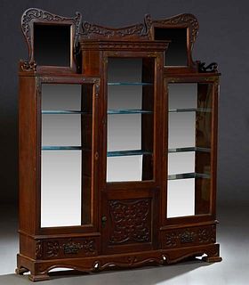 American Carved Oak Arts and Crafts Three Door Side-by-Side Display Cabinet, c. 1910, with a central incise carved back rail, over a long center glaze