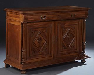 French Provincial Henri II Style Carved Walnut Sideboard, c. 1880, the ogee edge stepped top over two setback frieze drawers above double setback cupb