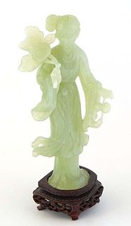 Asian Carved Jade Standing Kwn Yin Figure, 20th c., holding a flower, H.- 7 in., W.- 3 1/2 in., D.- 2 in.