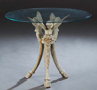 American Cast Iron Glass Top Patio Table, early 20th c., the later circular plate glass top on a support of three winged maidens, on cabriole legs wit