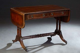 English Carved Mahogany Drop Leaf Sofa Table, 20th c., with an inset gilt tooled brown leather top over two frieze drawers, flanked by reeded rounded 