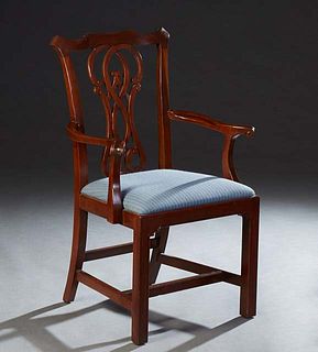 English Carved Mahogany Chippendale Style Armchair, early 20th c., the scrolled serpentine crest rail over a pierced vertical splat, flanked by two sc