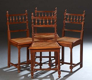 Set of Four French Henri II Style Carved Oak Dining Chairs, late 19th c., the curved spindled back with acorn finials, over a trapezoidal caned seat, 
