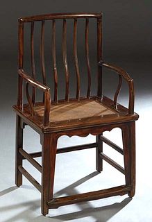 Ming-Style Carved Elm Armchair, 20th c., the curved spindled back to curved arms over rattan seats, joined by rectangular stretchers, H.- 40 in., W.- 