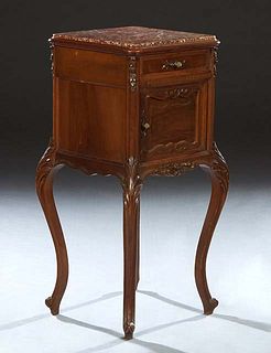 French Louis XV Style Carved Walnut Marble Top Nightstand, early 20th c., with an inset highly figured rouge marble over a frieze drawer and a cupboar