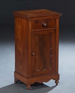 American Carved Mahogany Nightstand, late 19th c., the stepped top over a frieze drawer and a lower cupboard door, on a scalloped plinth base on turne