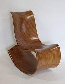 A Midcentury Style Wood Freeform Rocking Chair.