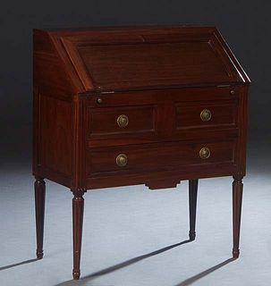 French Louis XVI Style Carved Cherry Secretary, 20th c., the slant lid with an inset gilt tooled leather writing surface, in front of an interior fitt