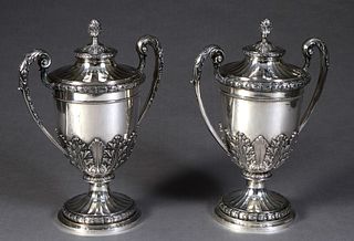 Pair of Large German .800 Silver Covered Urns, late 19th c., the artichoke handle ribbed lid on a base with a repousse band flanked by two swirled han