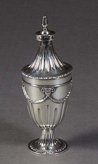 English Sterling Muffineer, 1831, London, maker's mark obscured, the pierced sloping lid on a base with relief rams' heads joined by relief garlands, 