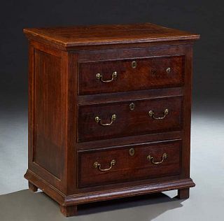 Diminutive English Carved Oak Chest, early 20th c., the rounded edge top over three drawers, on a plinth base on block feet, H.- 34 in., W.- 30 in., D