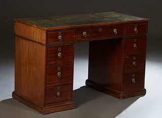 Victorian Mahogany Pedestal Desk, mid-19th century, in the Georgian taste, the rectangular top with three inset gilt tooled leather leather writing su