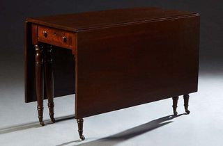 English Victorian Carved Mahiogany Drop Leaf Dining Table, 19th c., with one end frieze drawer, on turned tapered reeded legs with brass cap casters, 