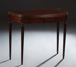 American Cherry and Walnut Gateleg Demilune Games Table, late 19th c., the reeded edge top opening to a gaming surface, on reeded tapered cylindrical 