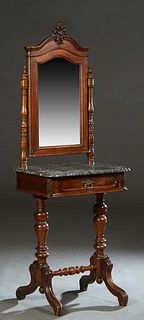 American Carved Walnut Marble Top Dressing Stand, late 19th c., the arched mirror with a pierced crown, on turned supports to a highly figured ogee ed