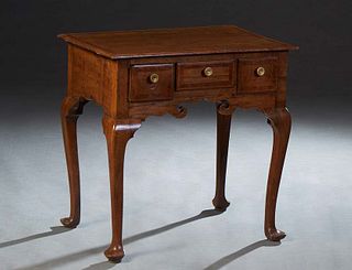 English Inlaid Carved Oak Lowboy, 19th c., the shaped rounded edge banded top over three frieze drawers above a scrolled skirt, on cabriole legs with 