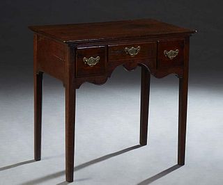 English Carved Oak Lowboy, early 20th c., the ogee rounded edge top over three frieze drawers, on turned tapered square legs, H.- 29 in., W.- 30 in., 
