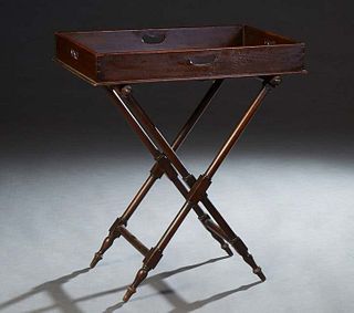 English Carved Mahogany Butler's Tray on Stand, 20th c., the galleried top with a hand hole on each side, on a folding mahogany X-shaped stand, H.- 34