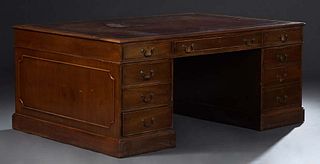 English Georgian Style Carved Mahogany Partner's Desk, c. 1900, the top with an inset gilt tooled red leather writing surface, over three frieze drawe
