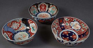 Three Japanese Imari Circular Porcelain Bowls, late 19th c., two with floral reserves and one with interior rooster reserves, in the typical Imari pal