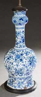 Delft Baluster Porcelain Vase, 20th c., with floral decoration in blue and white, now mounted on a stepped wood base and wired as a lamp, H.- 20 1/2 i