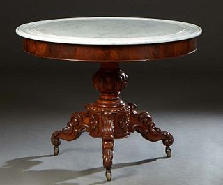 French Carved Walnut Marble Top Center Table, 19th c., the dished figural white circular marble over a wide skirt on a tapered urn support on tripodal