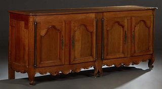 French Provincial Louis XV Style Carved Walnut Sideboard, 19th c., the two board ogee edge rounded corner top over two sets of double fielded panel cu