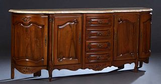 French Louis XV Style Carved Walnut Marble Top Sideboard, 20th c., the thick serpentine bowed pale ocher marble over a central bank of four drawers, f