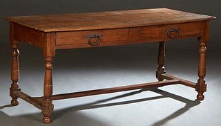 French Provincial Carved Walnut Farmhouse Table, 19th c., the stepped rectangular top over two frieze drawers, on turned tapered and block legs, joine