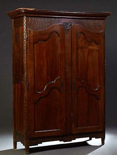 French Provincial Inlaid Carved Walnut Armoire, early 19th c., the stepped rounded corner crown over a carved frieze above double arched two panel doo