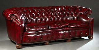 Leather Chesterfield Sofa, 20th c., in oxblood leather with iron tack decoration, the tufted rolled back flanked by rolled tufted arms, over a serpent