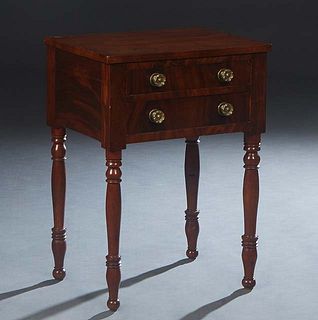 American Classical Carved Mahogany Night Stand, 19th c., the rectangular top over a bank of two drawers with period brass pulls, on turned tapered leg
