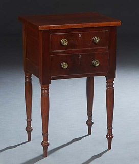 American Classical Carved Mahogany Night Stand, 19th c., the rectangular top over a bank of two drawers with brass pulls, on turned tapered legs, H.- 