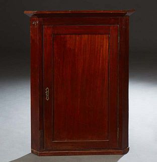 English Carved Mahogany Hanging Corner Cabinet, late 19th c., the sloping three sided crown over a large cupboard door, on a plinth base, H.- 38 1/2 i