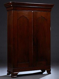 Large Carved Walnut Gothic Double Door Armoire, c. 1860, possibly New Orleans, with a deep stepped ogee crown over Gothic arched double doors, the who