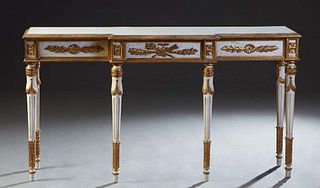 Italian Gilt and Polychromed Console Table, 20th c., the gilt ogee edge breakfront top over applied gilt carved sides, on turned tapered cylindrical r