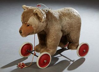 Steiff Bear on Wheels Pull Toy, 20th c., with growler, with the Steiff buttton in the left ear, H.- 24 in., W.- 12 in., D.- 31 in.