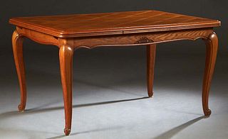 French Louis XV Style Carved Oak Drawleaf Dining Table, 20th c., the parquetry inlaid stepped rounded corner top over a carved skirt, with two draw le