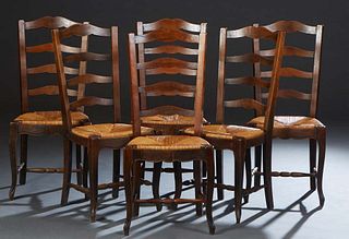 Set of Six French Provincial Louis XV Carved Cherry Rushseat Side Chairs, 20th c., the high arched curved ladderback over a bowed slip rush seat, on c