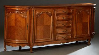 French Provincial Louis XV Style Carved Cherry Bow front Sideboard, 20th c., the stepped ogee edge parquetry inlaid bowed top over a central bank of f