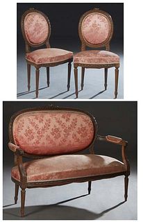 French Louis XVI Style Carved Beech Three Piece Parlor Suite, early 20th c., consisting of a settee with a floral carved crest rail over an oval uphol